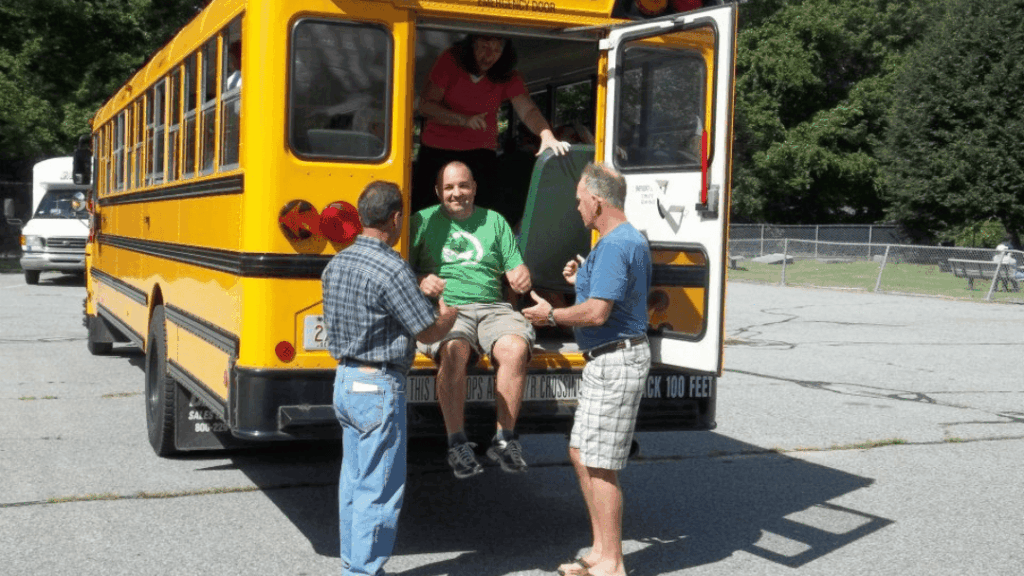 Charter bus in Massachusetts taking groups on scenic fall foliage tours along New England routes with vibrant autumn colors