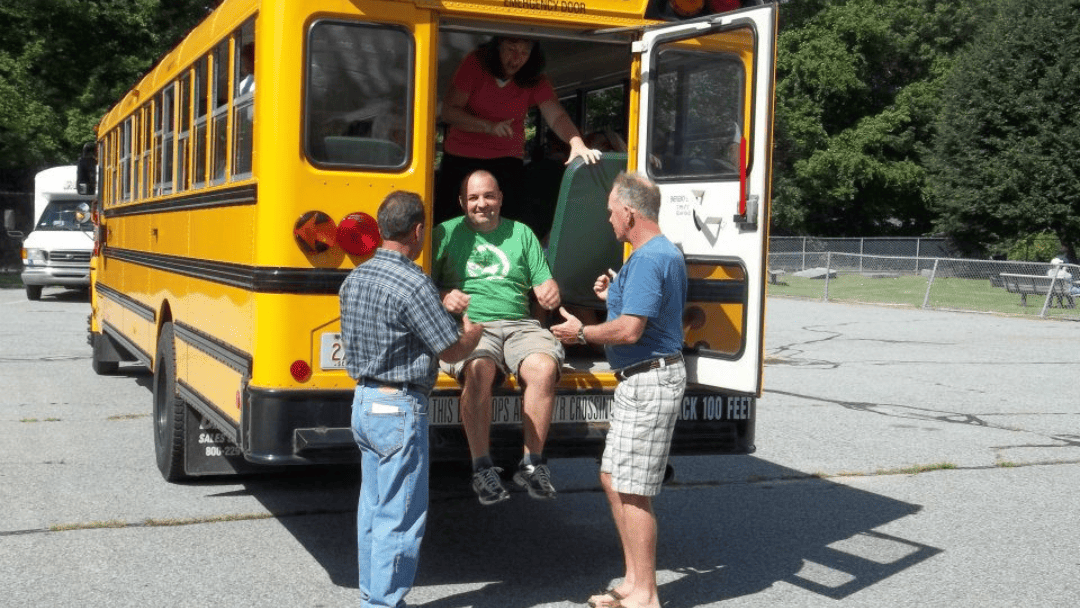 Charter bus in Massachusetts taking groups on scenic fall foliage tours along New England routes with vibrant autumn colors