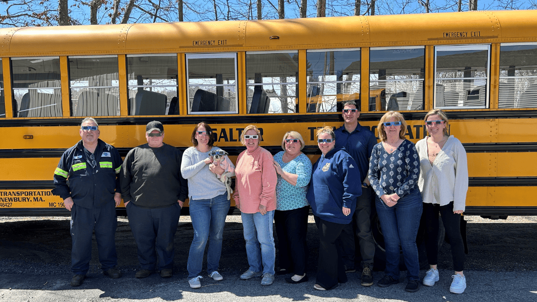 Corporate retreat transportation tips MA showing employees boarding a charter bus for a fall team event in Massachusetts