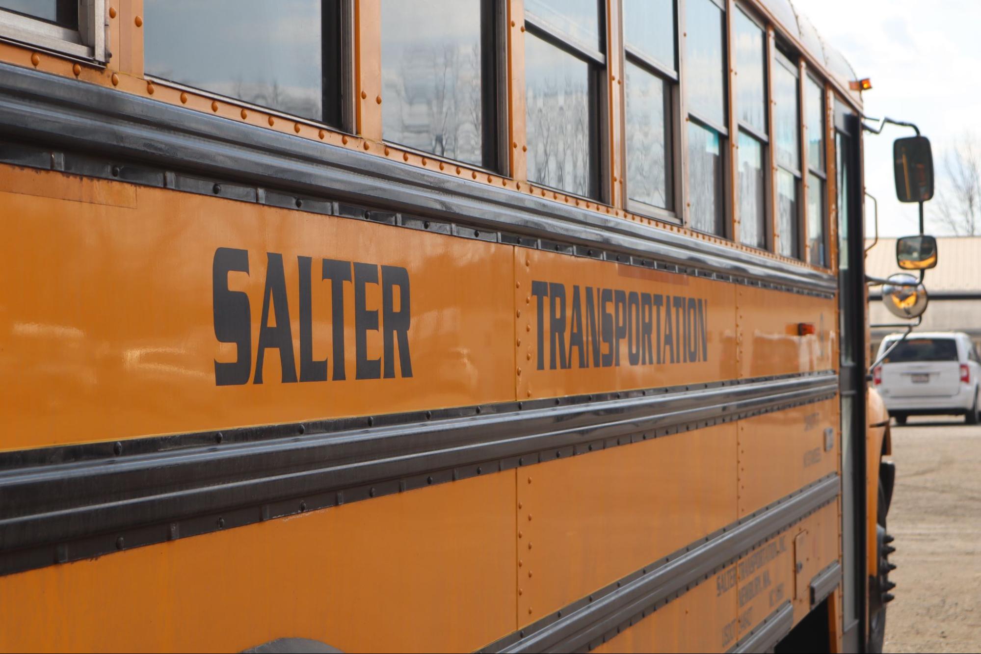 Students boarding a school bus for a Massachusetts field trip in the fall